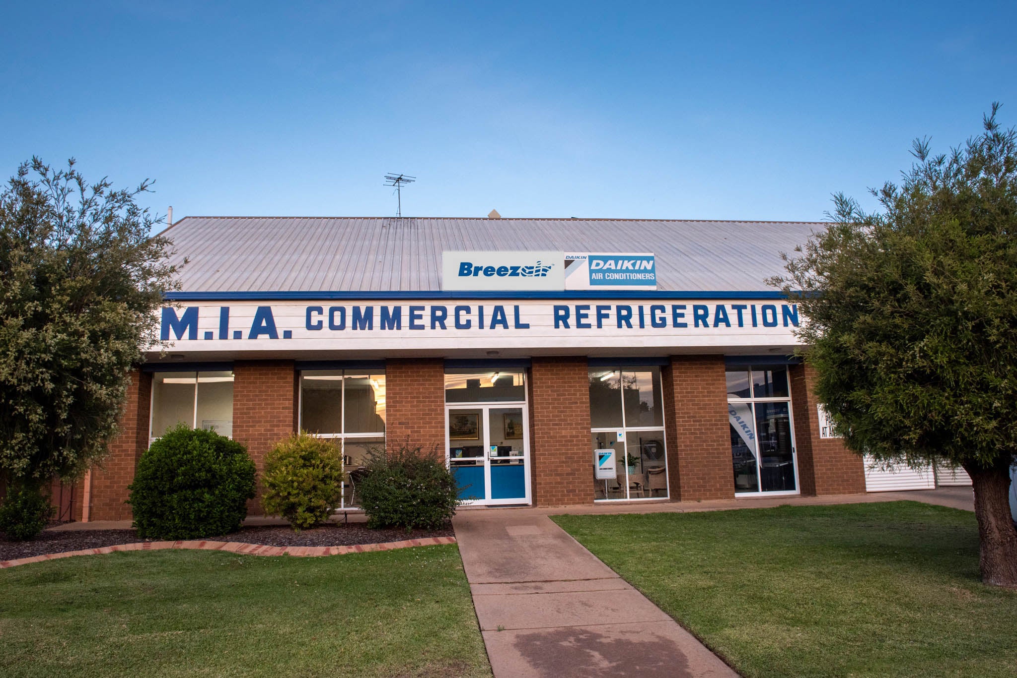 MIA Commercial Refrigeration building with Breezair and Daikin logos on a clear day.
