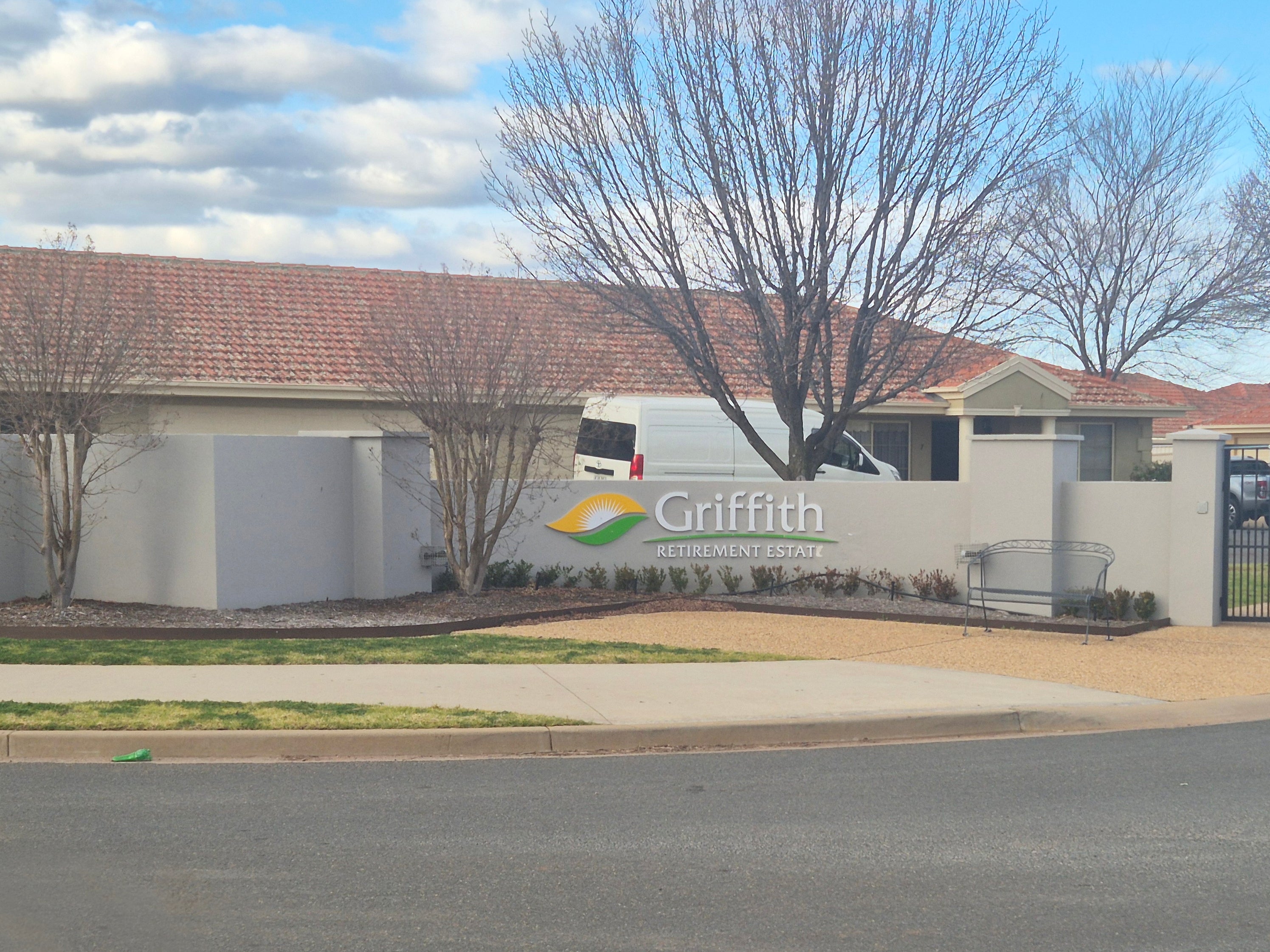 Griffith Retirement Estate building with a clear sky and trees in the background