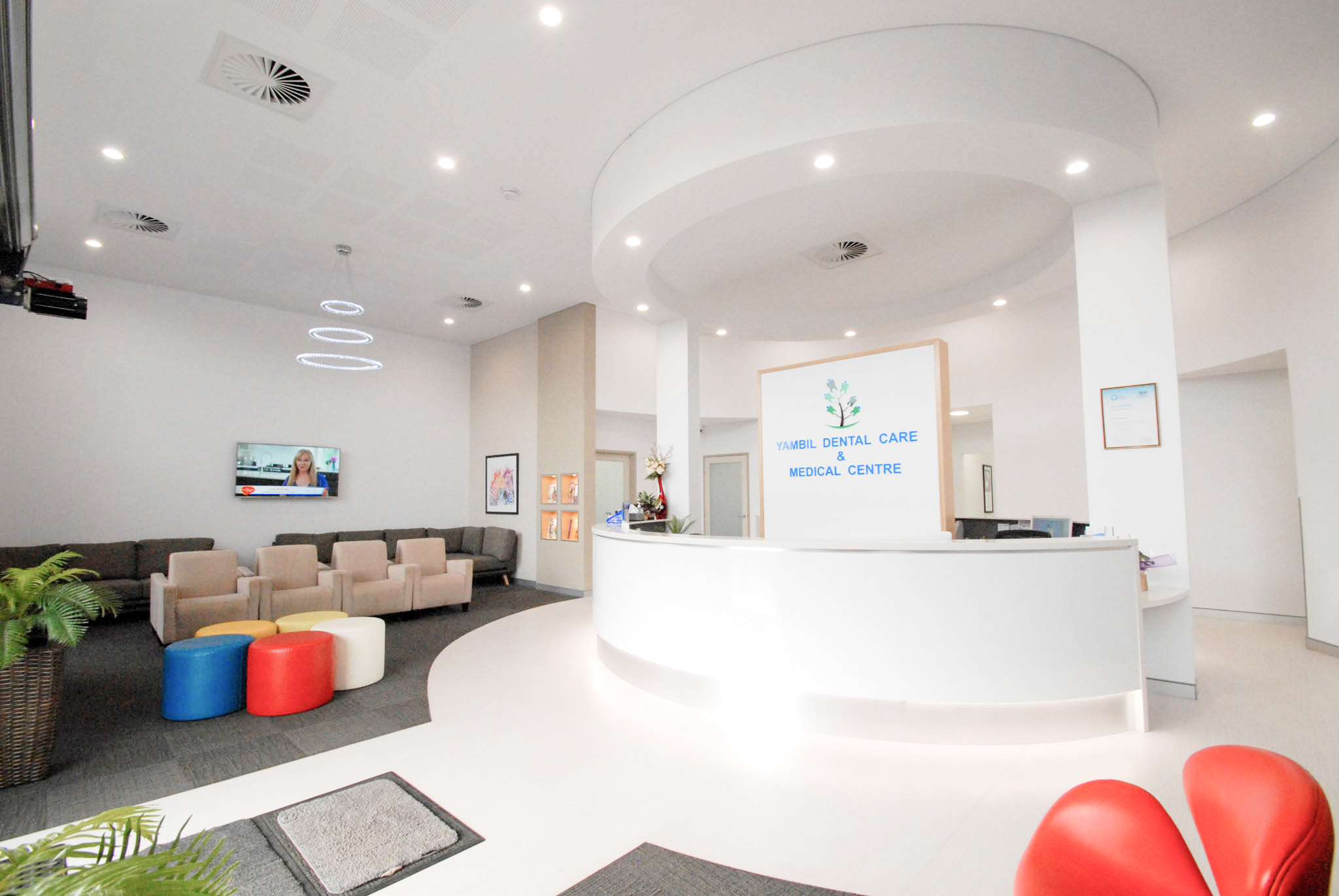 Modern office lobby with reception desk and seating area